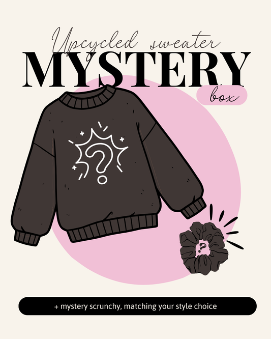 Upcycled sweater mystery box with a sweater and scrunchie on a pink background